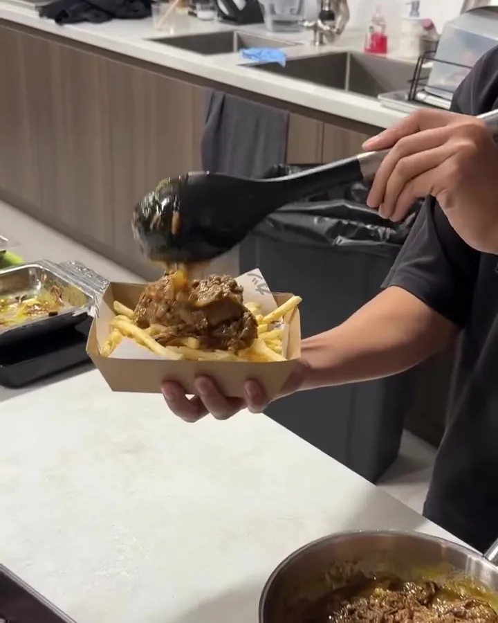 Fillings being served into a takeaway tray in the kitchen