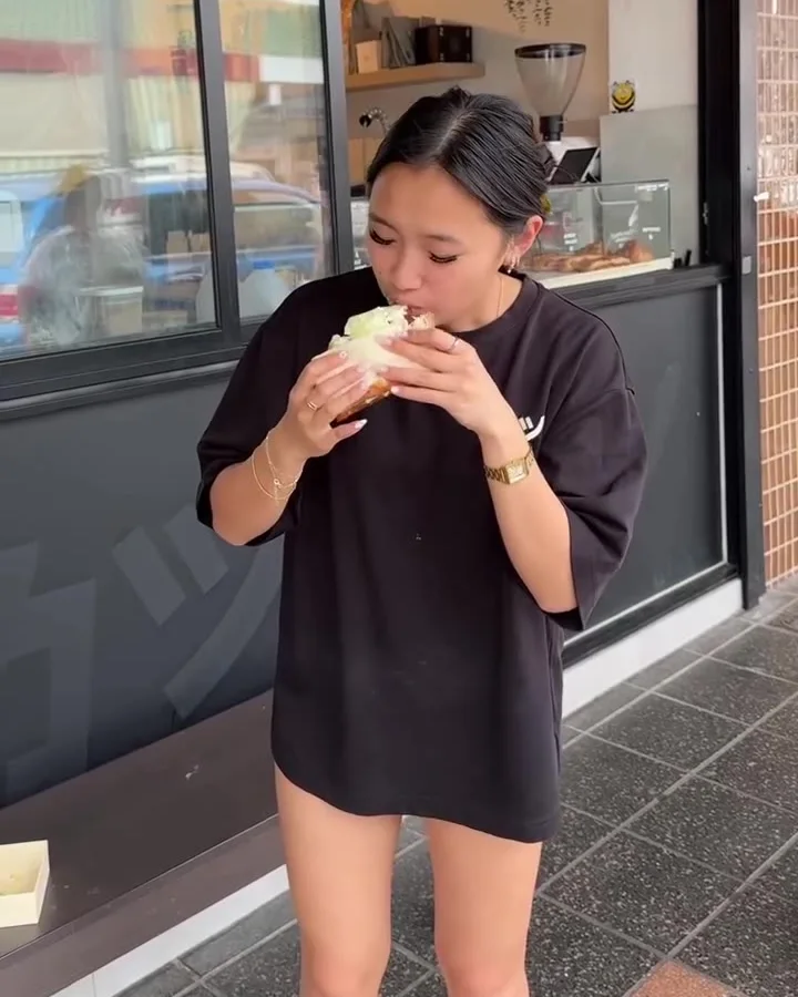 A first bite of the OG Sando outside the カツ shopfront