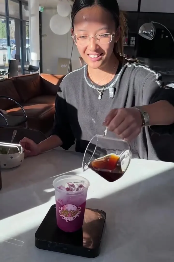 A purple layered drink on the counter scale
