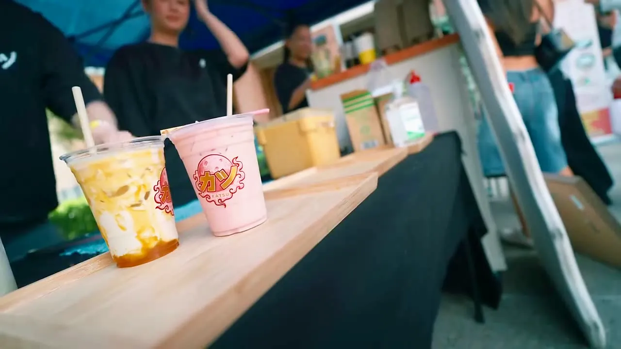 Two Katsu drinks on the counter of a pop-up stall