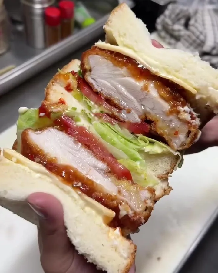The OG Sando cut open: chicken katsu, tomato and lettuce on milk bread